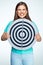 Emotional young woman holding round target.