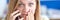 Emotionally confused woman talking on phone closeup