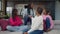 Emotionally stressed black teenage sisters arguing on sofa