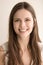 Emotive headshot portrait of happy young woman