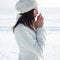 Emotive portrait of fashionable model in white coat and beret