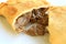 Empanada de Pino or beef filled Empanada, delicious Chilean baked savory pasty served on white plate