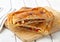 Empanada slices on a wooden cutting board.