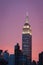 Empire state building with bright purple sky at sunset - New York city