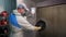 Employee applies lacquer on welder mask near exhaust fan