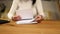 Employee business woman hands working in stacks paper files for searching