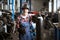 Employee of a car repair shop stands with welding machine