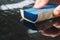 An employee of the car wash thoroughly washes conducts detaling and applies protective equipment to the body of an expensive car