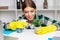 Employee of a cleaning company in overalls and yellow gloves cleans the office