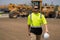 employee construction man in vest protective hardhat walking outdoor with copy space. caucasian construction manager