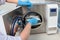 An employee of a dental clinic puts instruments for sterilization in a heat-resistant Cabinet. An unrecognizable photo without a