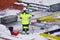 Employee with electronic leveling instrument at the construction site.