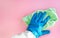 Employee hand in rubber protective glove with micro fiber cloth wiping wall from dust. Maid or housewife cares about house. Spring