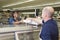 Employee Handing Product To Customer In Supermarket