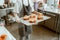 Employee holds tray with fresh croissants decorated with burnt cream in craft bakery shop