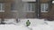 Employee monitors the safety of work for others. Occupational Safety and Health. Throwing white snow from the roof of a