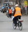 The employee of the municipal service for cleaning the streets on a Bicycle