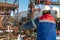 An employee of an oil company performs work in an oil field well.