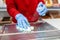 The employee performs sanitary cleaning by wiping the scales with an antiseptic wipes. Hands in medical gloves close-up. Concept