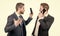 employee show smartphone to boss. men partners gesturing at business negotiations.