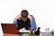 Employee sits clasping his head with his fists at the office table