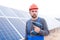 A employee of the solar cell station, holds a drill in his hands.