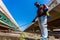 An employee sprays disinfectant on a outside of train as a precaution against a new at