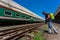 An employee sprays disinfectant on a outside of train as a precaution against a new coronavirus at