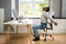 Employee Stretching At Office Desk