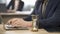 Employee typing on laptop at desk, hourglass trickling, deadline approaching