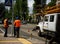 Employee In Uniform Controls The Process Of Road Repairs.