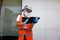 Employee wearing PPE take orders from customers at the drive thru of a fastfood restaurant