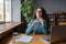 Employee wellbeing. Happy female office worker resting at workplace, taking break to prevent stress