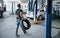 Employee with wheel. Mechanic holds a tire at the repair garage. Replacement of winter and summer tires