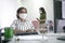 Employees or businesswomen with face masks back to work at office