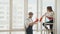 Employees of a cleaning company clean a house or apartment. A man and a woman wash windows in an apartment after repairs