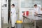 Employees cleaning restaurant kitchen after service