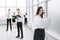 Employees of the company standing in a spacious office lobby.