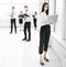 Employees of the company standing in a spacious office lobby.