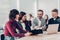 Employees discuss working documents sitting at a Desk