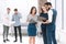 Employees discussing business documents in the office lobby