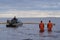 Employees of the environmental service clean up after low tide on the coast  Gulf of Finland remove garbage, oil spills, harmful