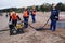 Employees of the environmental service clean up after low tide on the coast  Gulf of Finland remove garbage, oil spills, harmful