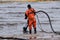 Employees of the environmental service clean up after low tide on the coast  Gulf of Finland remove garbage, oil spills, harmful