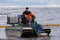 Employees of the environmental service clean up after low tide on the coast  Gulf of Finland remove garbage, oil spills, harmful