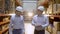 Employees male warehouse workers engineers in hard hat working in logistics center factory construction site, two