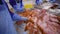 Employees of the meat factory spread chicken fillet with paprika marinade to prepare for the Smoking process.