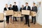 Employees In Office Holding Cardboard Boxes