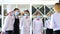 Employees of a restaurant in protective masks after quarantine. Interaction with restaurant manager and his staff on the