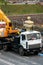 Employees of the road service in special yellow vests perform work on the repair of the roadway. Restoration of the deformation